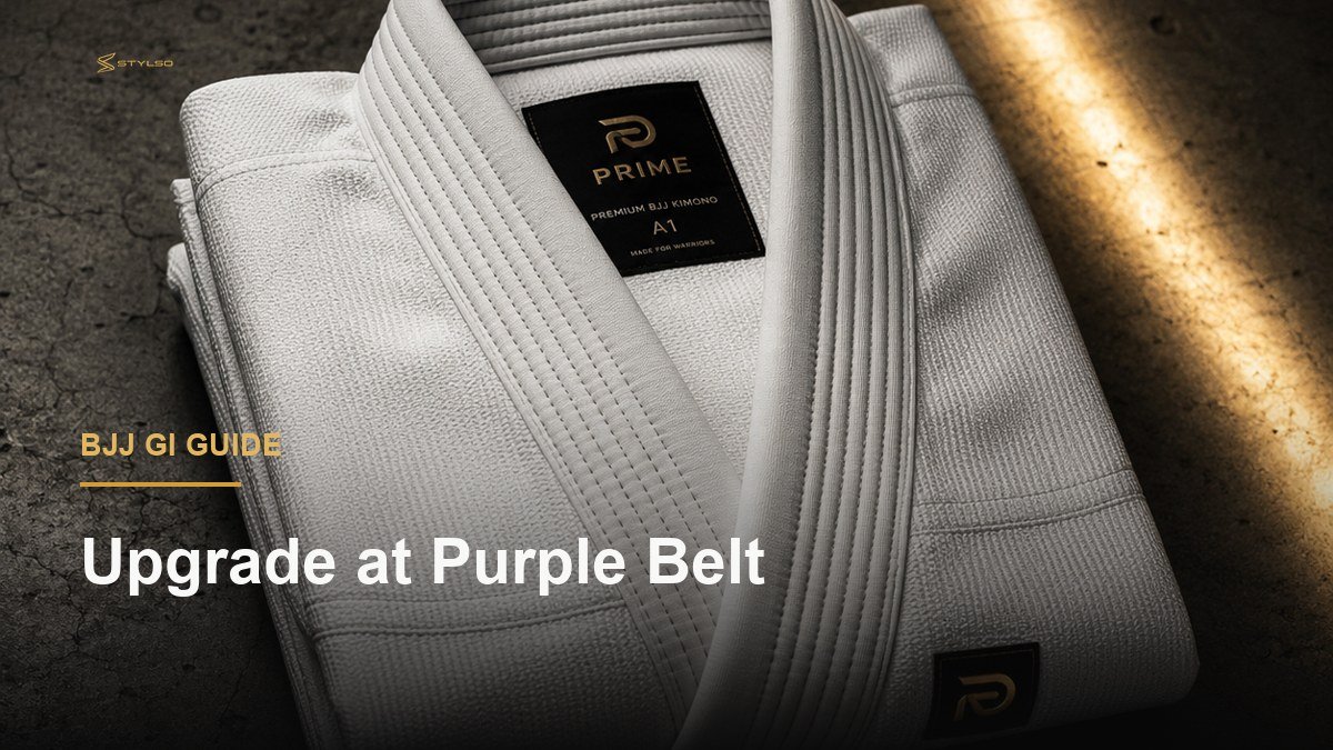 A white Stylso pearl weave BJJ gi folded neatly on a dark surface, showing premium fabric quality for purple belt grapplers
