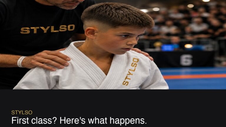 A child bowing in with their BJJ trainer before class, wearing a white Stylso gi — first class ready